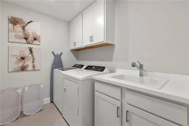 a view of storage and utility room with two washing machine