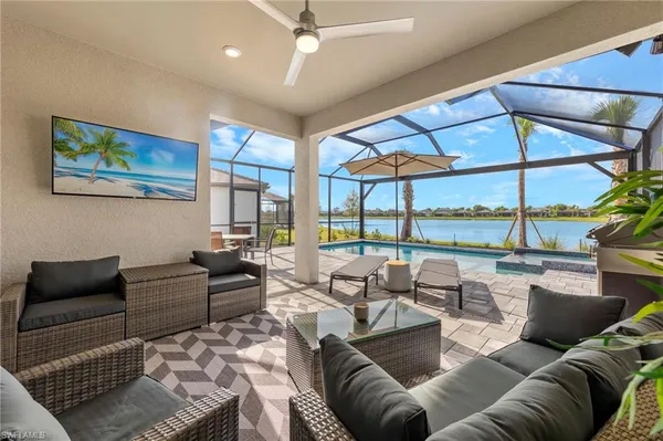 a living room with furniture and a floor to ceiling window