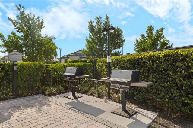 a view of a bench in the backyard of a house