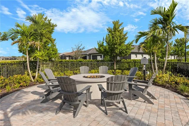 a view of patio with table and chairs and potted plants