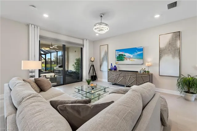 a living room with furniture and a chandelier