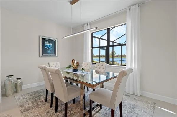 a view of a dining room with furniture and a window
