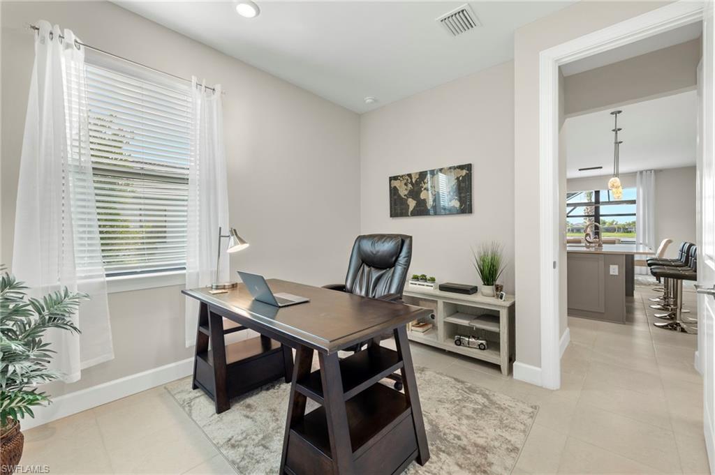 2147 Yellowfin Circle Naples, FL 34114 - Photo 10 of 34 a workspace with furniture and a potted plant