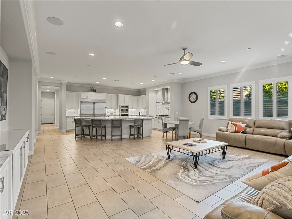 8775 Helena Avenue Las Vegas, NV 89129 - Photo 19 of 72 Living area with crown molding, light tile patterned floors, recessed lighting, and a ceiling fan