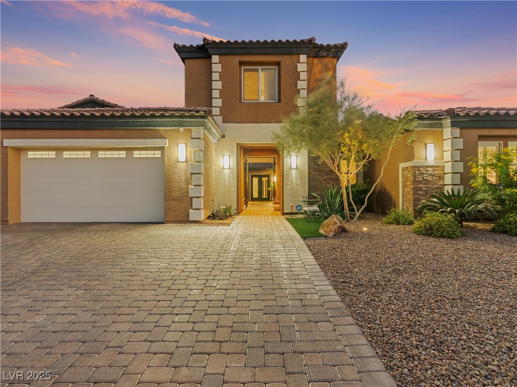 8775 Helena Avenue Las Vegas, NV 89129 - Photo 2 of 72 Mediterranean / spanish-style home with stucco siding, a garage, decorative driveway, and a tile roof