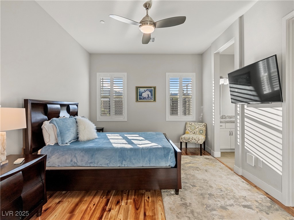 8775 Helena Avenue Las Vegas, NV 89129 - Photo 28 of 72 Bedroom featuring connected bathroom, light wood finished floors, and ceiling fan