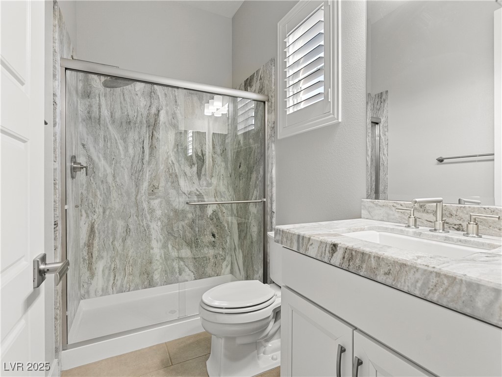 8775 Helena Avenue Las Vegas, NV 89129 - Photo 39 of 72 Full bathroom with vanity, light tile patterned flooring, and a marble finish shower