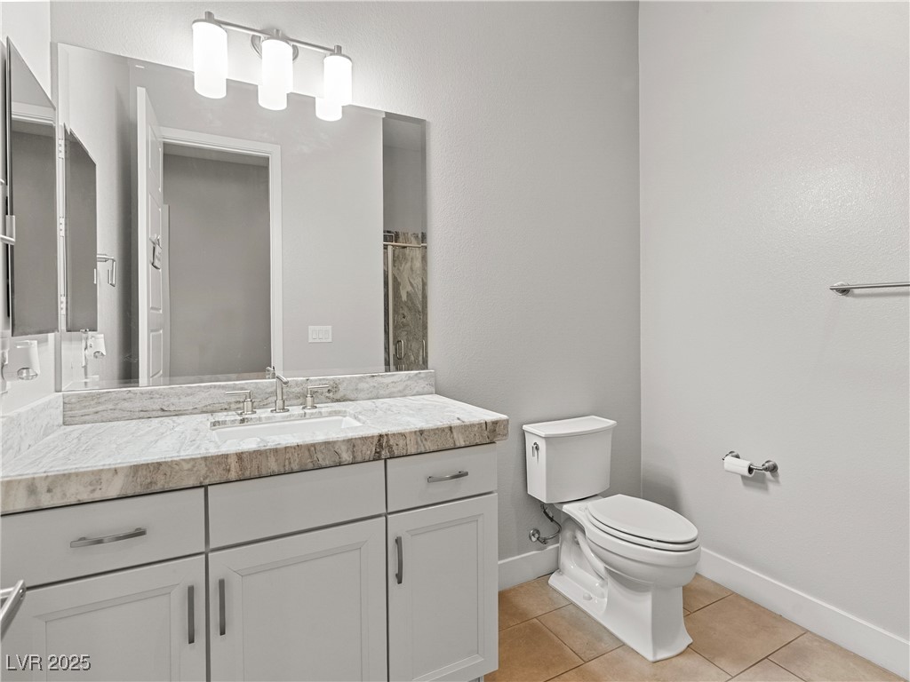 8775 Helena Avenue Las Vegas, NV 89129 - Photo 43 of 72 Bathroom with vanity, light tile patterned floors, and curtained shower