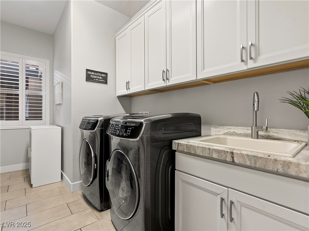 8775 Helena Avenue Las Vegas, NV 89129 - Photo 45 of 72 Laundry room with independent washer and dryer, light tile patterned floors, and cabinet space