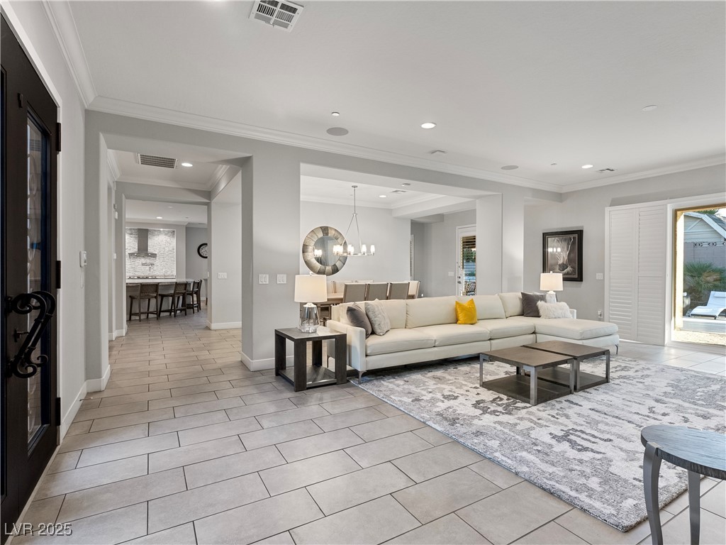 8775 Helena Avenue Las Vegas, NV 89129 - Photo 5 of 72 Living room featuring ornamental molding, light tile patterned flooring, recessed lighting, and a chandelier