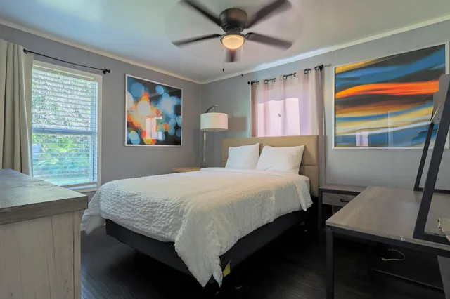 a bedroom with a bed window and a table