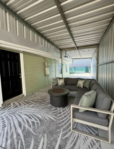 a living room with furniture and a ceiling fan