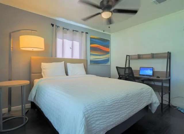 a bedroom with a bed and window