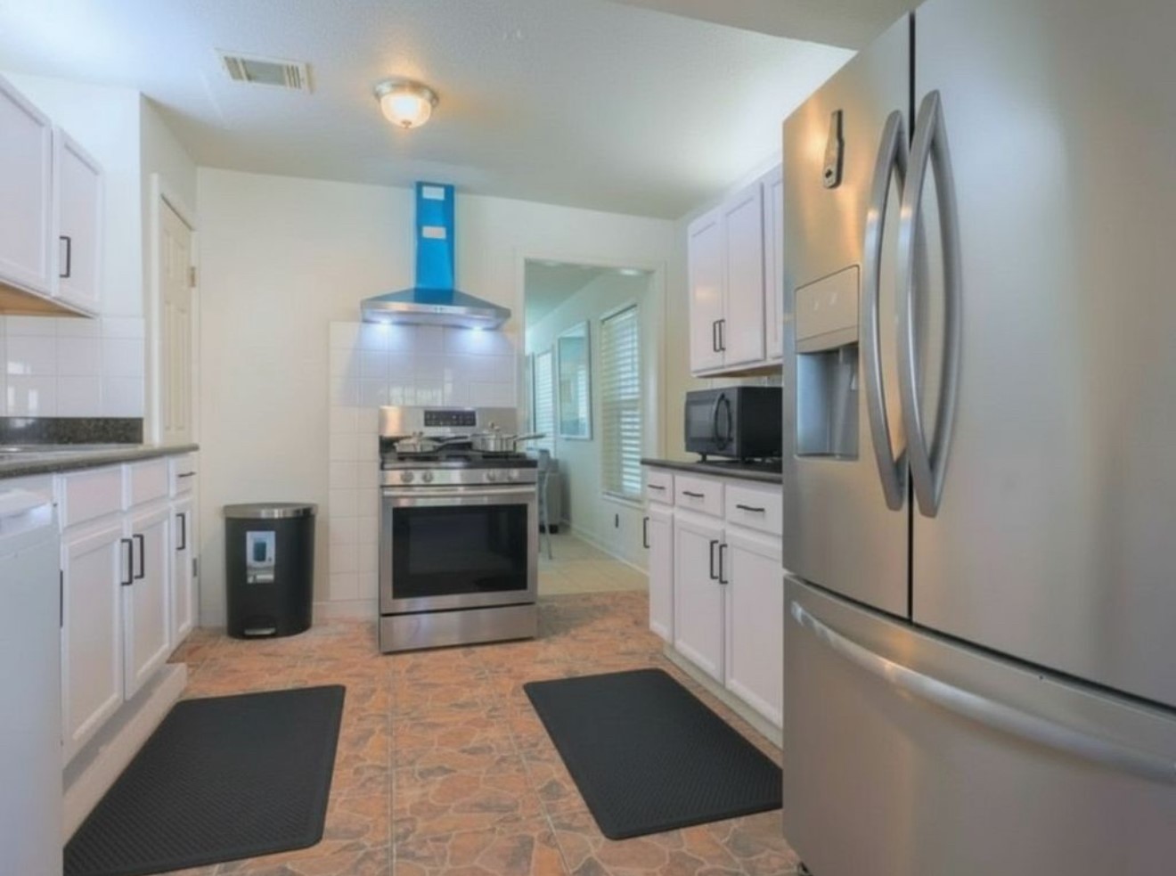 831 Rouse Street Houston, TX 77020 - Photo 5 of 19 a kitchen with stainless steel appliances a refrigerator stove and microwave