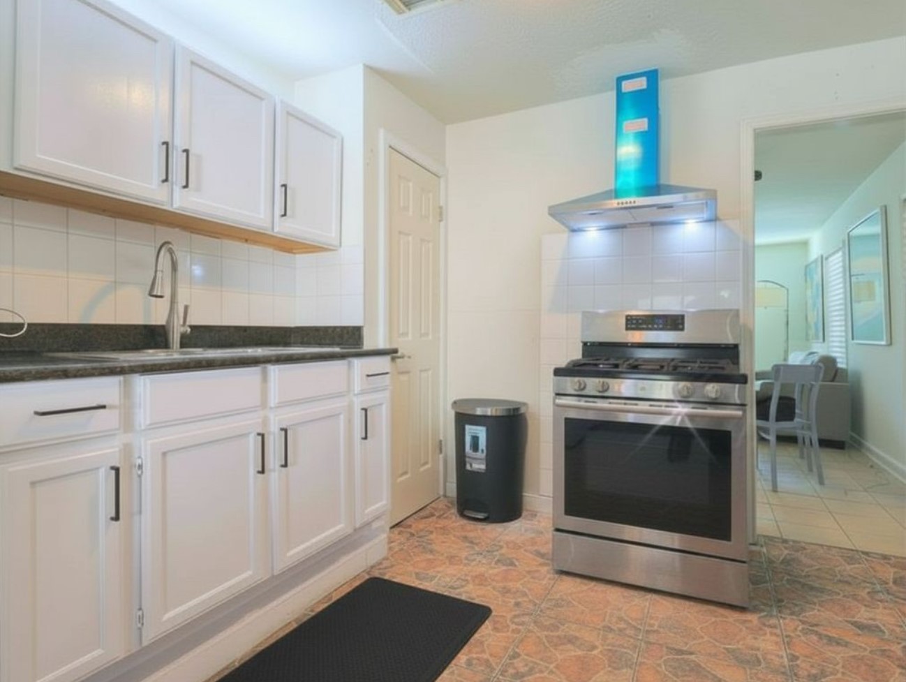 831 Rouse Street Houston, TX 77020 - Photo 6 of 19 a kitchen with granite countertop white cabinets and stainless steel appliances