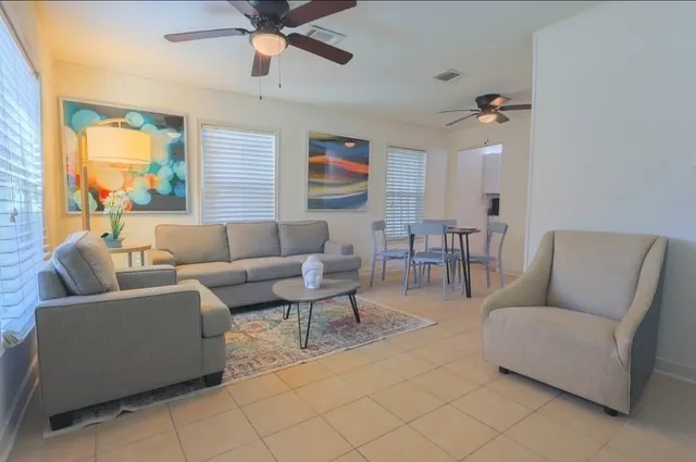 a living room with furniture and a wooden floor