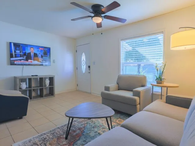 a living room with furniture and a chandelier