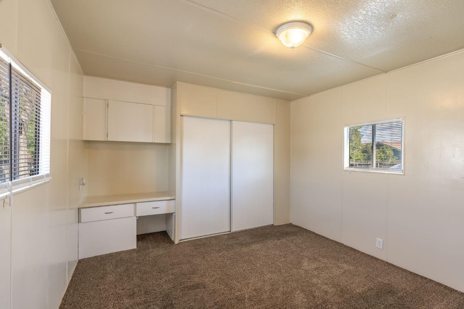 5835 Cherokee Road, Unit 7 Stockton, CA 95215 - Photo 12 of 16 an empty room with a empty space and windows