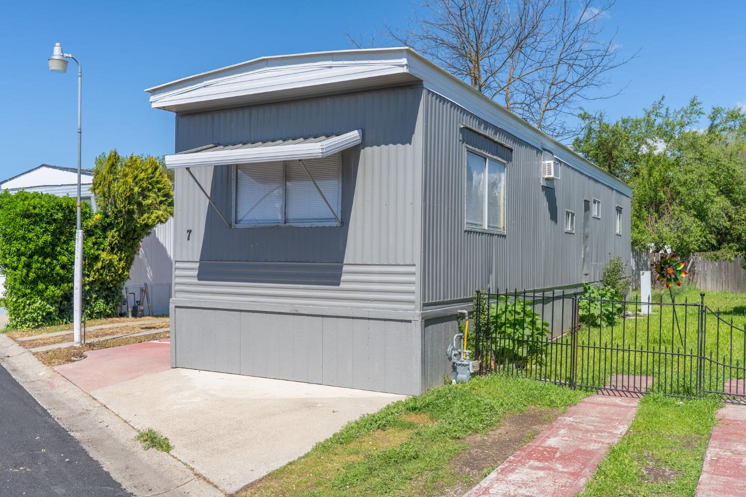 5835 Cherokee Road, Unit 7 Stockton, CA 95215 - Photo 2 of 16 a front view of a house with garden