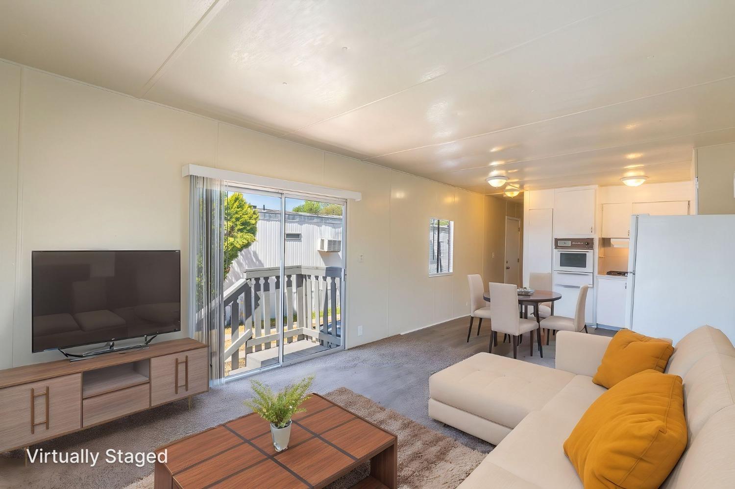 5835 Cherokee Road, Unit 7 Stockton, CA 95215 - Photo 6 of 16 a living room with furniture and a flat screen tv