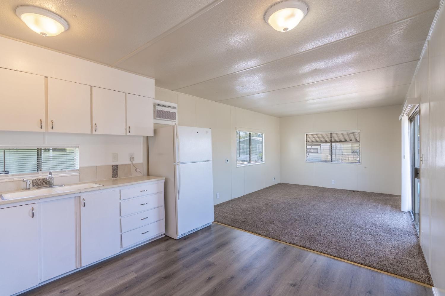 5835 Cherokee Road, Unit 7 Stockton, CA 95215 - Photo 8 of 16 a kitchen with cabinets and wooden floor