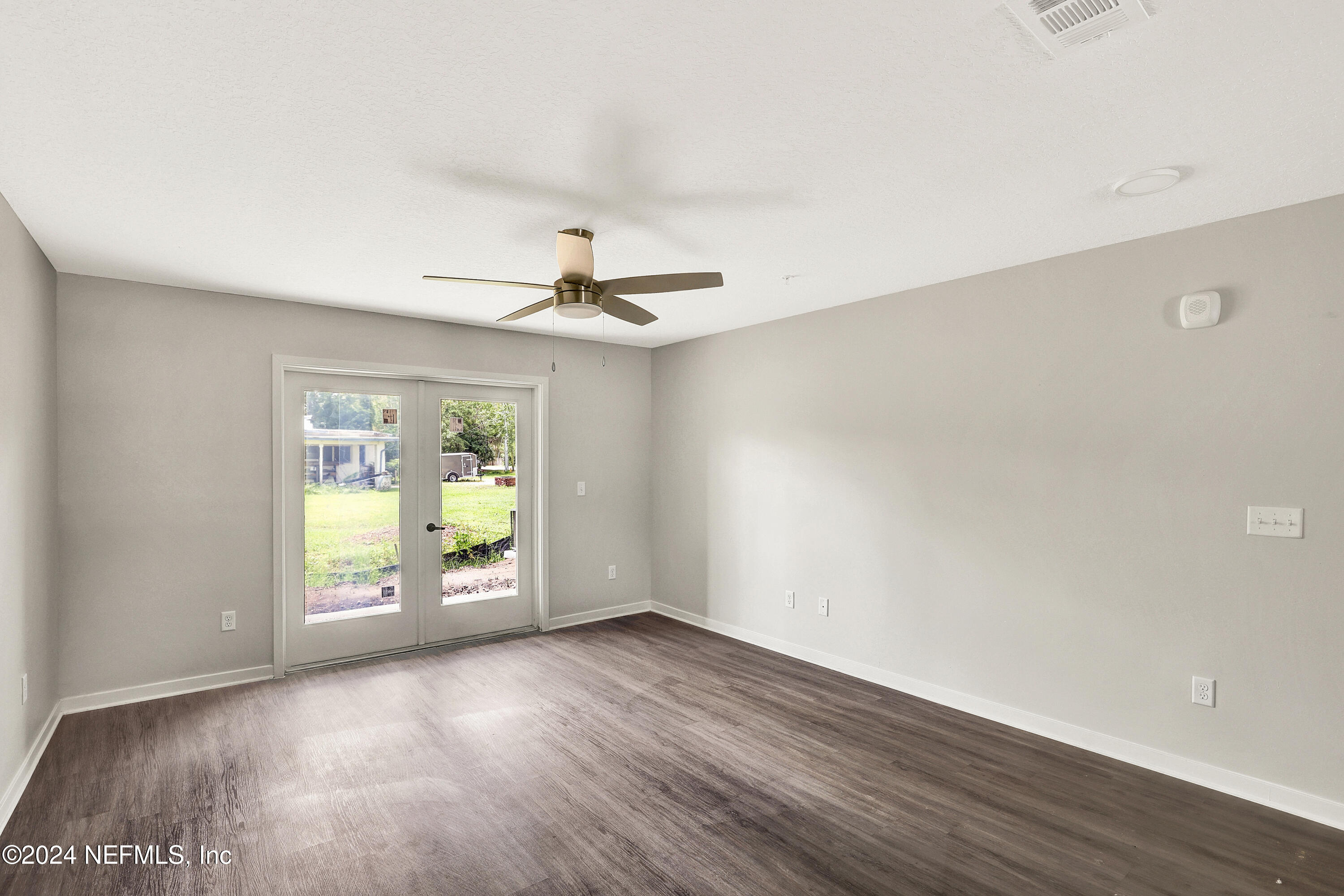 10109 Old St Augustine Road, Unit 1104 Jacksonville, FL 32257 - Photo 7 of 10 a view of an empty room with a window and wooden floor