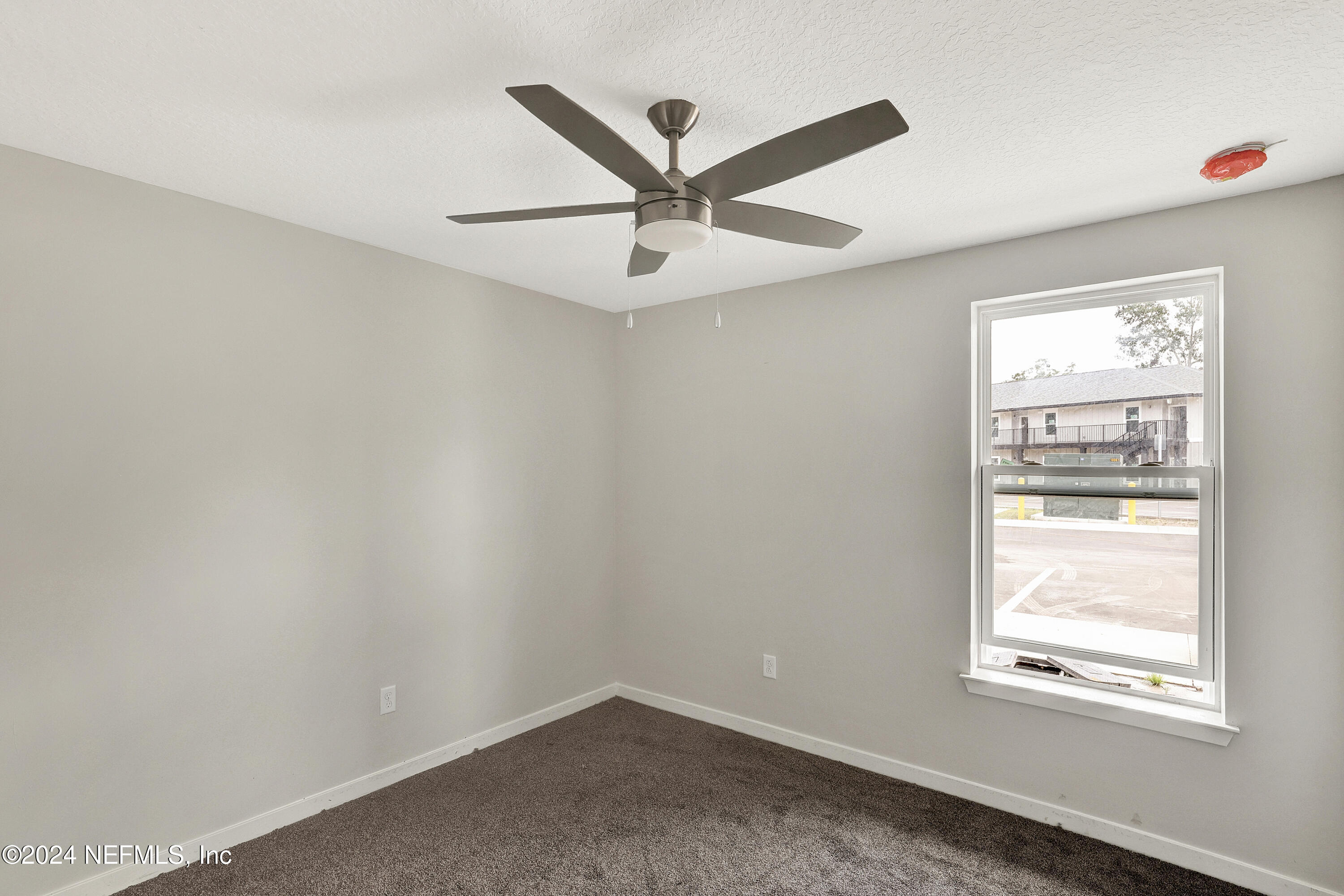 10109 Old St Augustine Road, Unit 1104 Jacksonville, FL 32257 - Photo 9 of 10 an empty room with ceiling window and ceiling fan