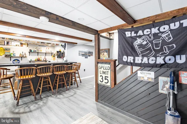 a dining area with chairs and wooden floor