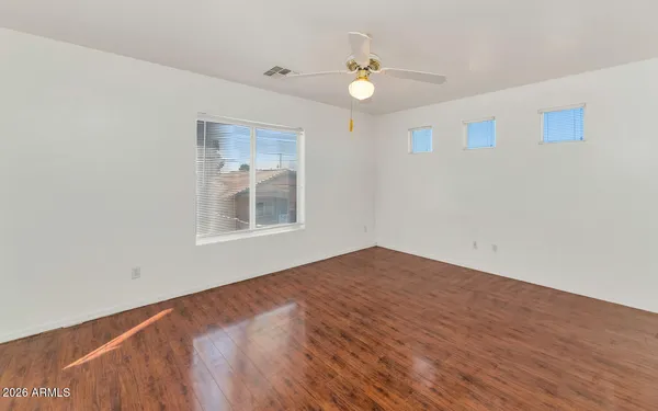 a view of an empty room with wooden floor
