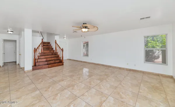 a kitchen with stainless steel appliances granite countertop a refrigerator a sink dishwasher and white cabinets with wooden floor