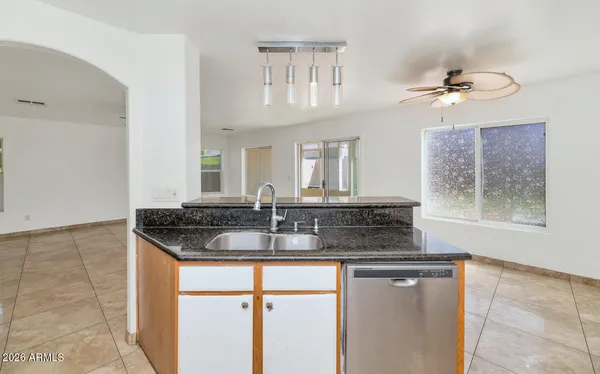 a large kitchen with stainless steel appliances kitchen island granite countertop a large counter top and a stove top oven