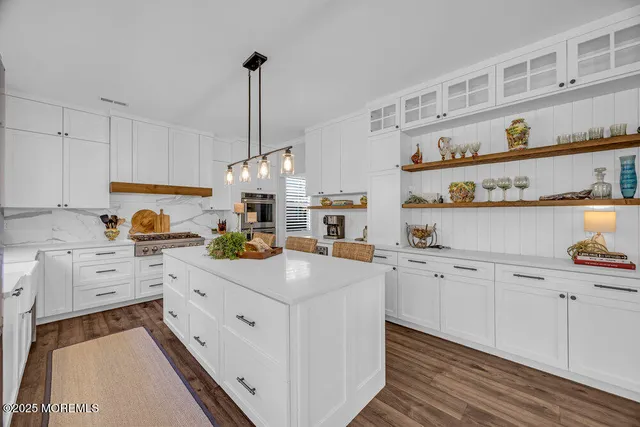 a view of a kitchen with furniture and large windows