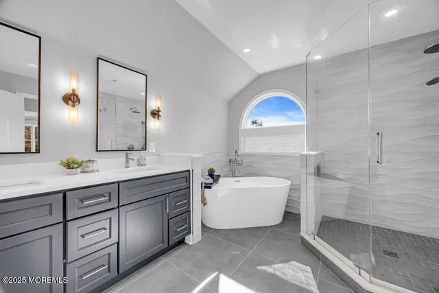 a bathroom with a double vanity sink and a mirror