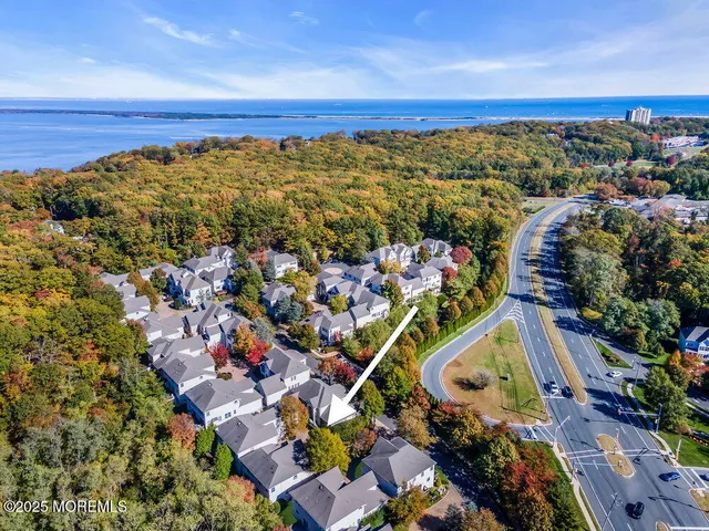 a view of a livingroom with wooden floor and stairs