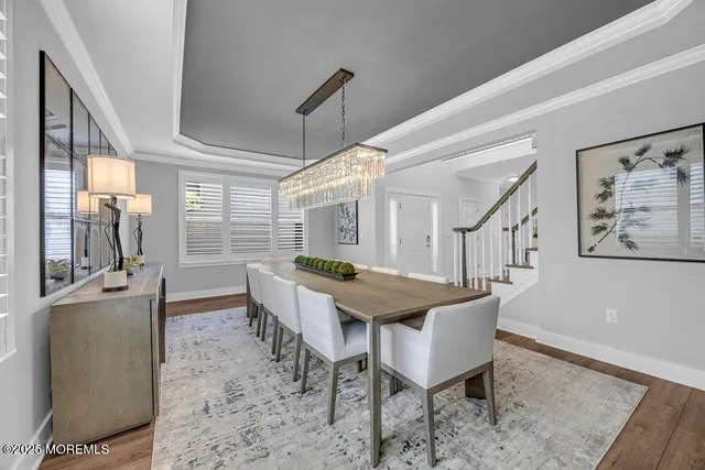 a dining room with furniture and a wooden floor