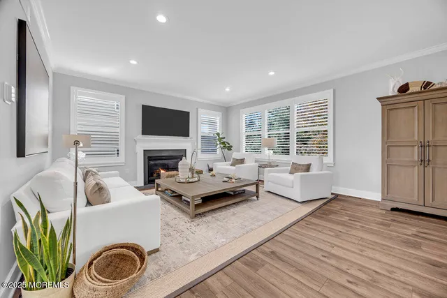 a living room with furniture fireplace and flat screen tv