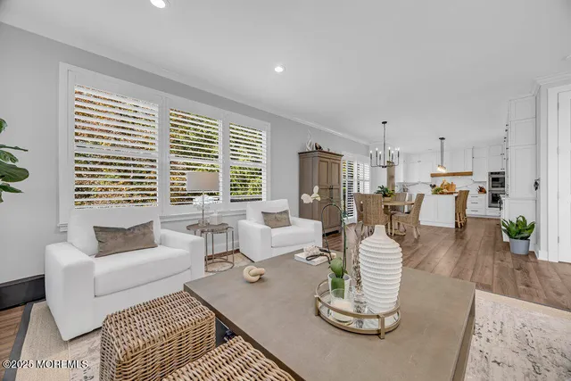 a kitchen with stainless steel appliances a dining table chairs and a refrigerator