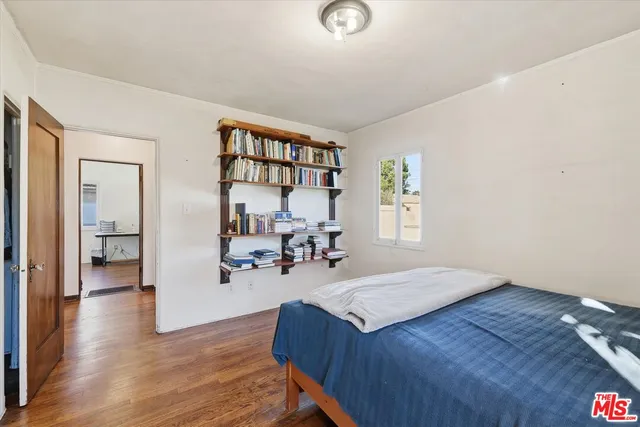 a bedroom with furniture and wooden floor