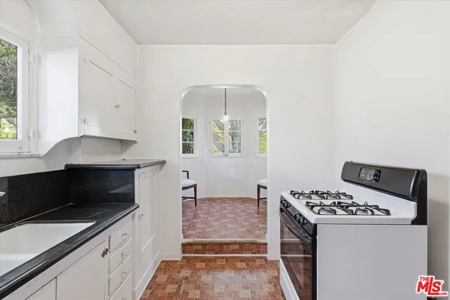 a kitchen with a stove and a refrigerator