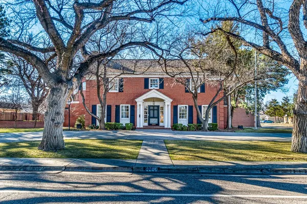 a front view of a house with yard and green space
