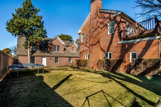 a view of swimming pool with a backyard and a tree