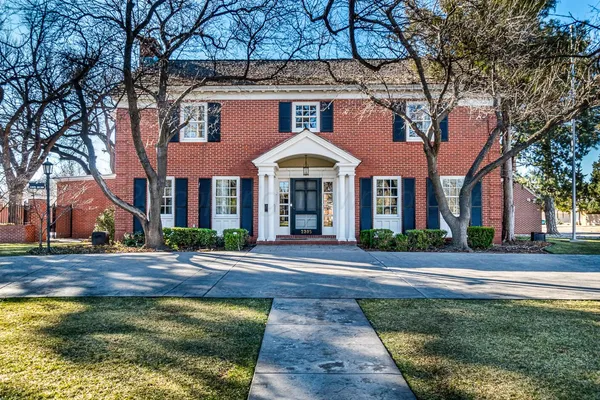 a front view of a brick house with a large windows