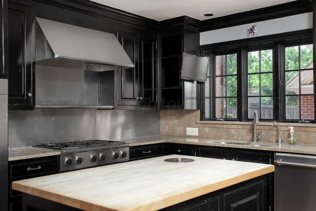 a view of a room with furniture and wooden floor