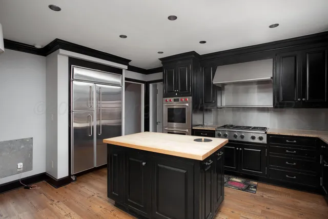 a bathroom with a granite countertop sink a toilet a mirror and a tub