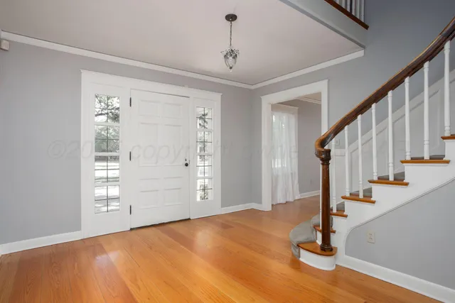 a view of empty room with wooden floor and cabinet