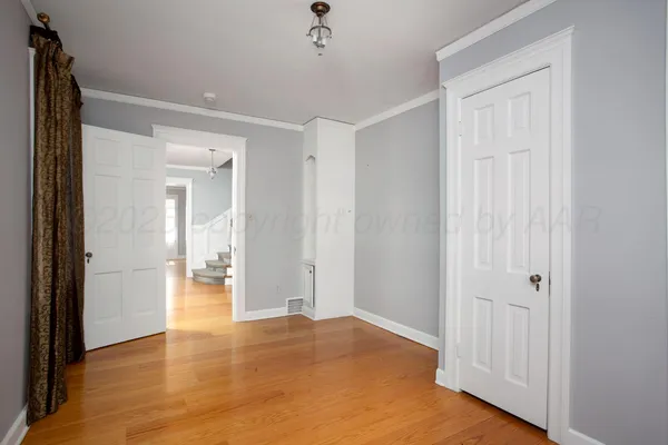 a view of room with window and wooden floor