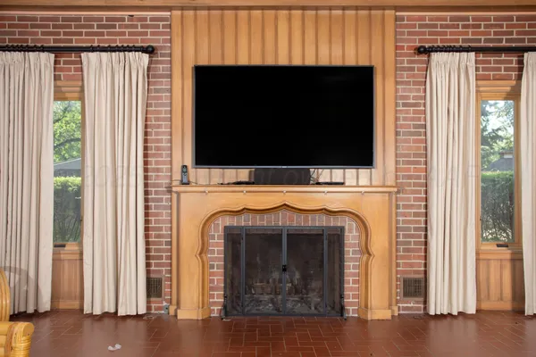 a view of a room with a ceiling fan and window