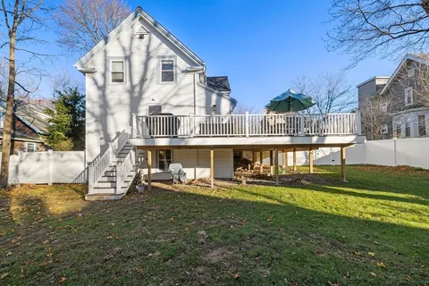 a front view of a house with a yard table and chairs