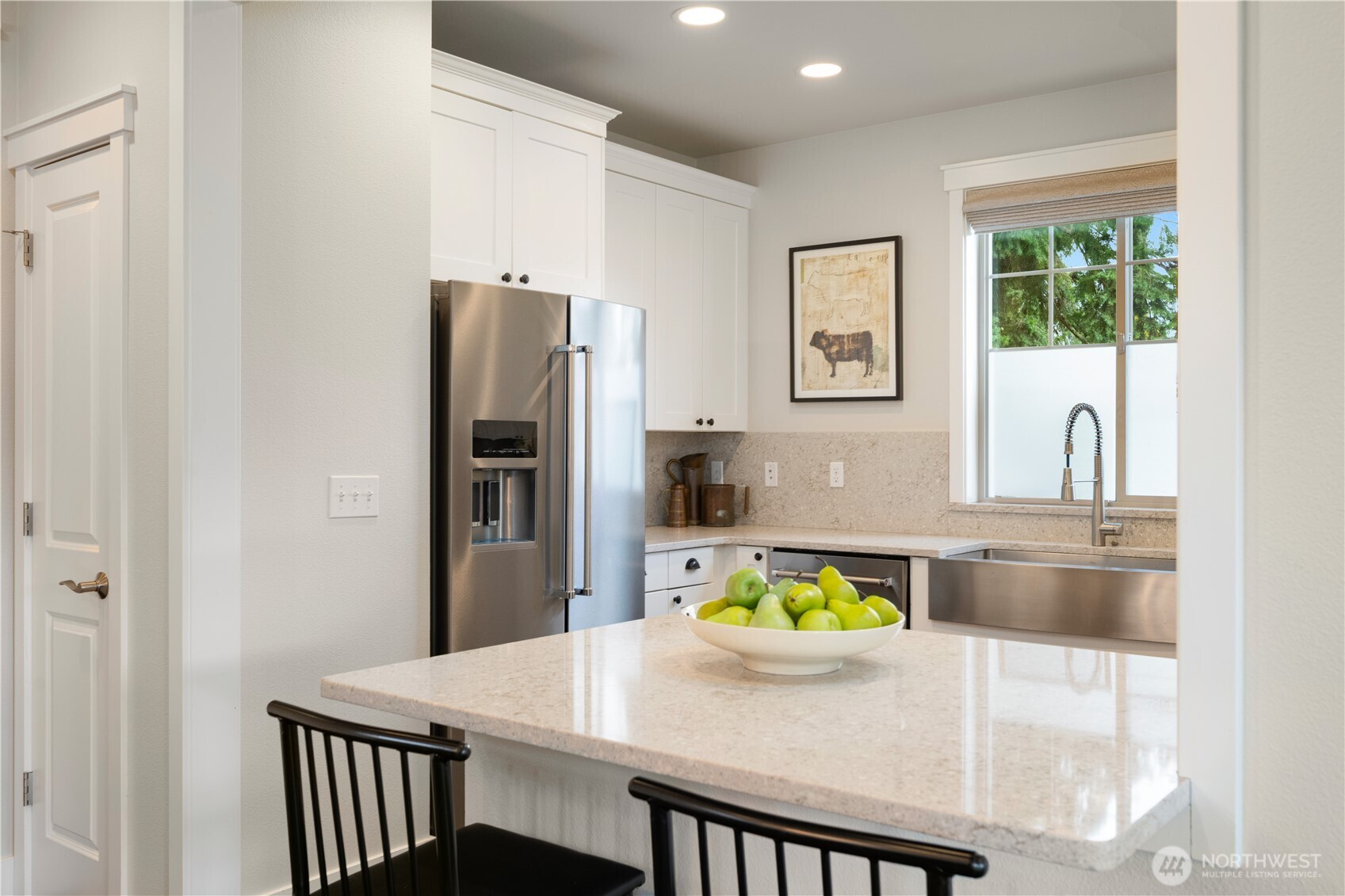 7709 17th Avenue Southwest Seattle, WA 98106 - Photo 12 of 37 a kitchen with kitchen island a refrigerator and a stove