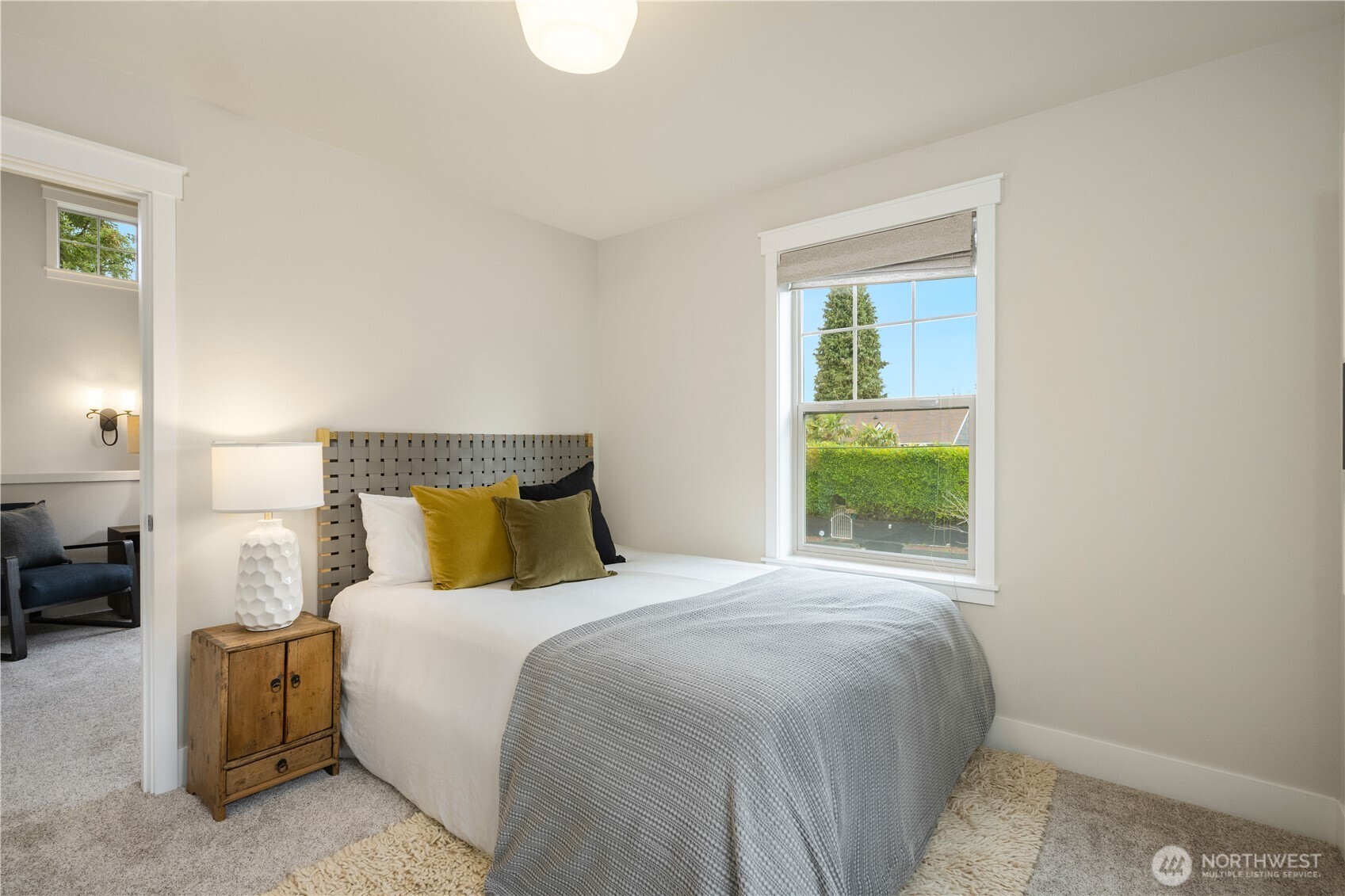 7709 17th Avenue Southwest Seattle, WA 98106 - Photo 27 of 37 a bedroom with a bed and a window